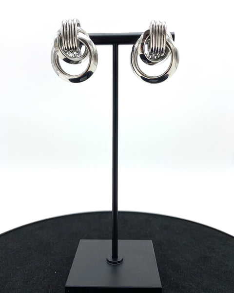 multi-round metal circle design. Assembled by hand with a pin-on clip and molded with the highest stainless steel quality and sterling silver-dipped.