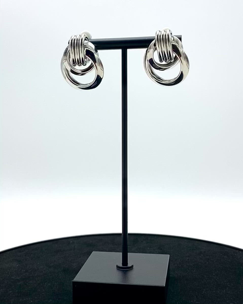 multi-round metal circle design.   Assembled by hand with a pin-on clip and molded with the highest stainless steel quality and sterling silver-dipped.