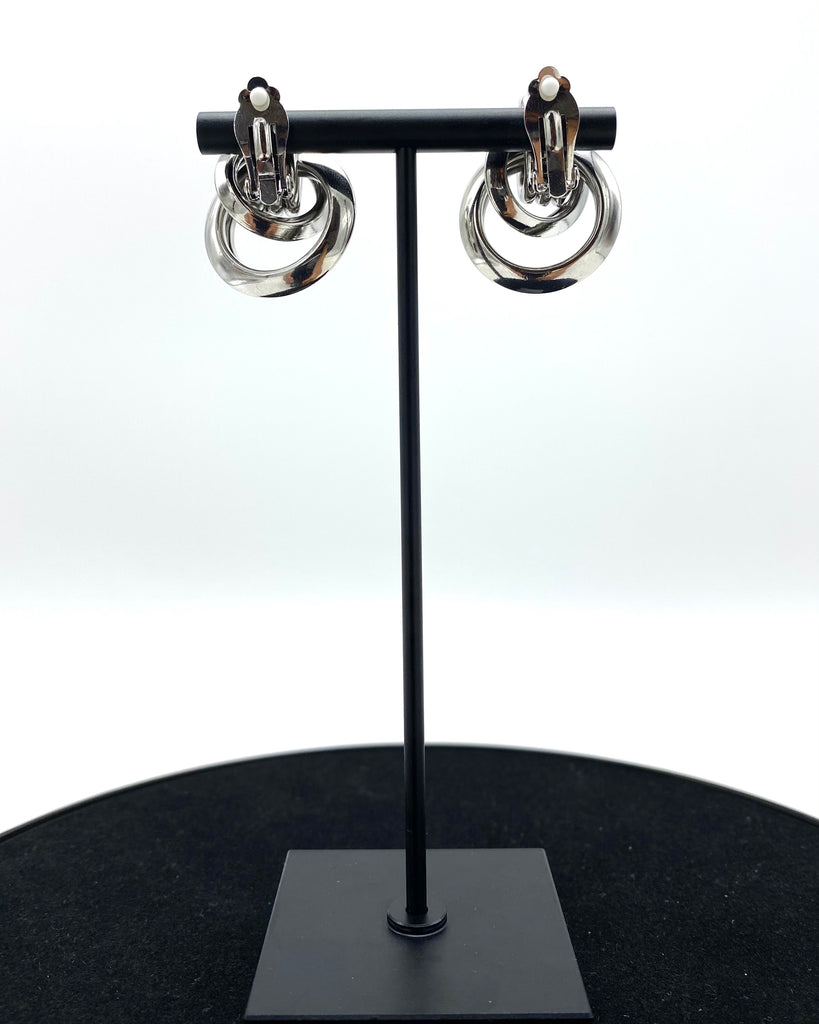 multi-round metal circle design.   Assembled by hand with a pin-on clip and molded with the highest stainless steel quality and sterling silver-dipped.
